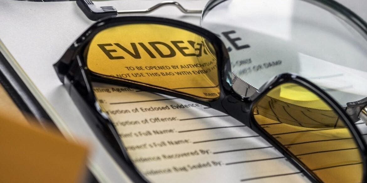 Glasses UV for criminology on police records, conceptual image Criminal Investigative Services- Criminal Investigation, Indagini Difensive E Investigazioni Preventive Penali